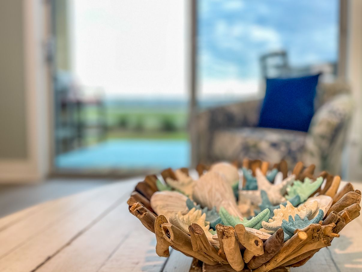 Side View of Seashells and Starfishes in a Wooden Bowl